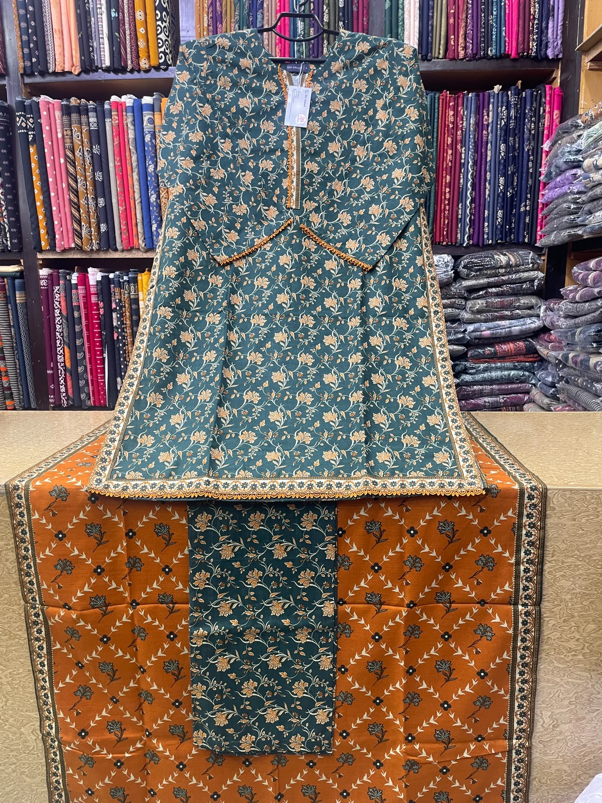 Option 1 (SEO Focused): Bin Saeed Printed Khaddar 3-Piece Suit – Dark Teal Floral Shirt, Matching Trouser & Rust Printed Dupatta